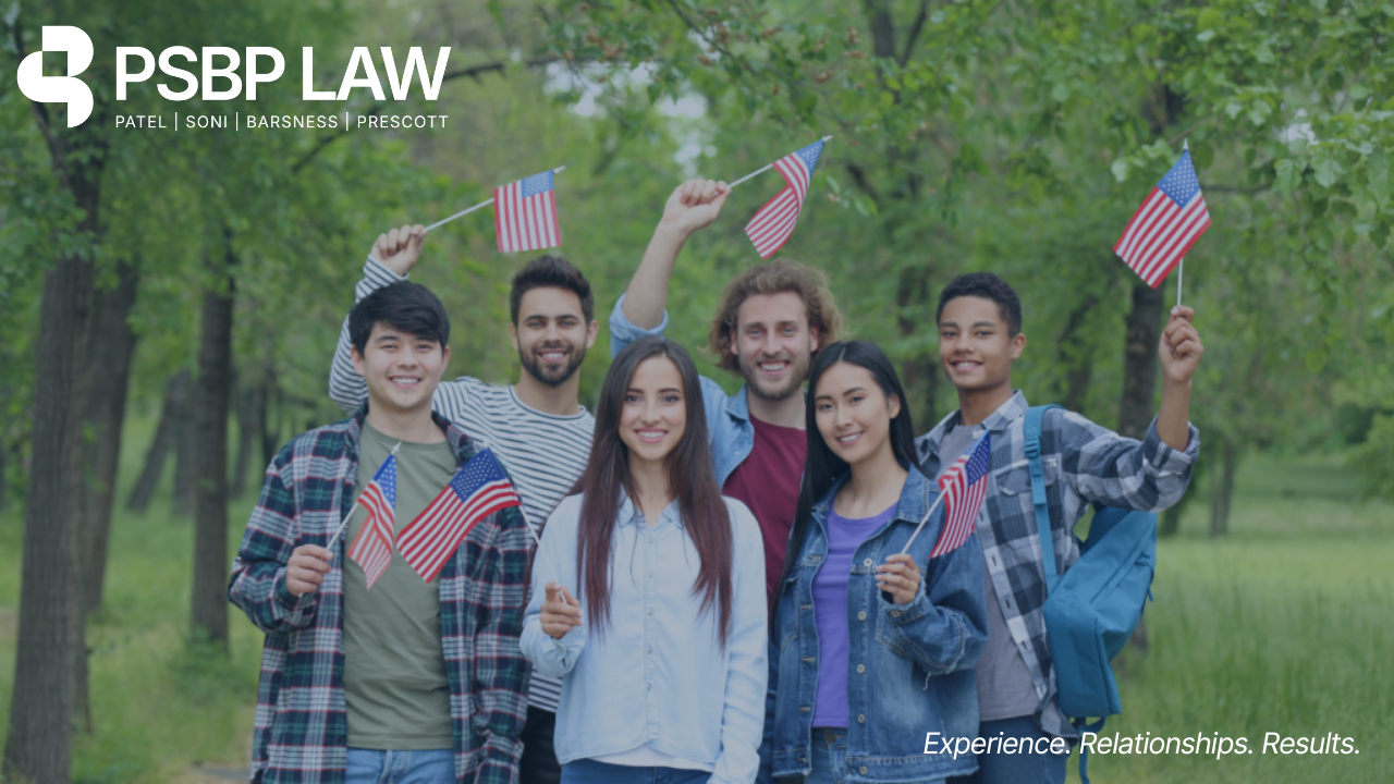 Group of young people holding American flags outdoors with PSBP Law branding.