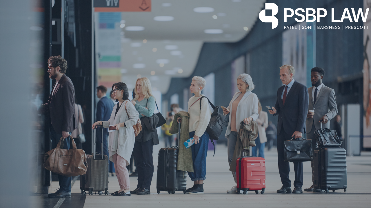 Travelers with luggage standing in line at an airport terminal — Overstayed Due to I-94 Mistake?